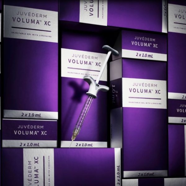 Juvéderm Voluma XC packets and a syringe on display, showcasing the dermal filler used for facial volume restoration and contouring.