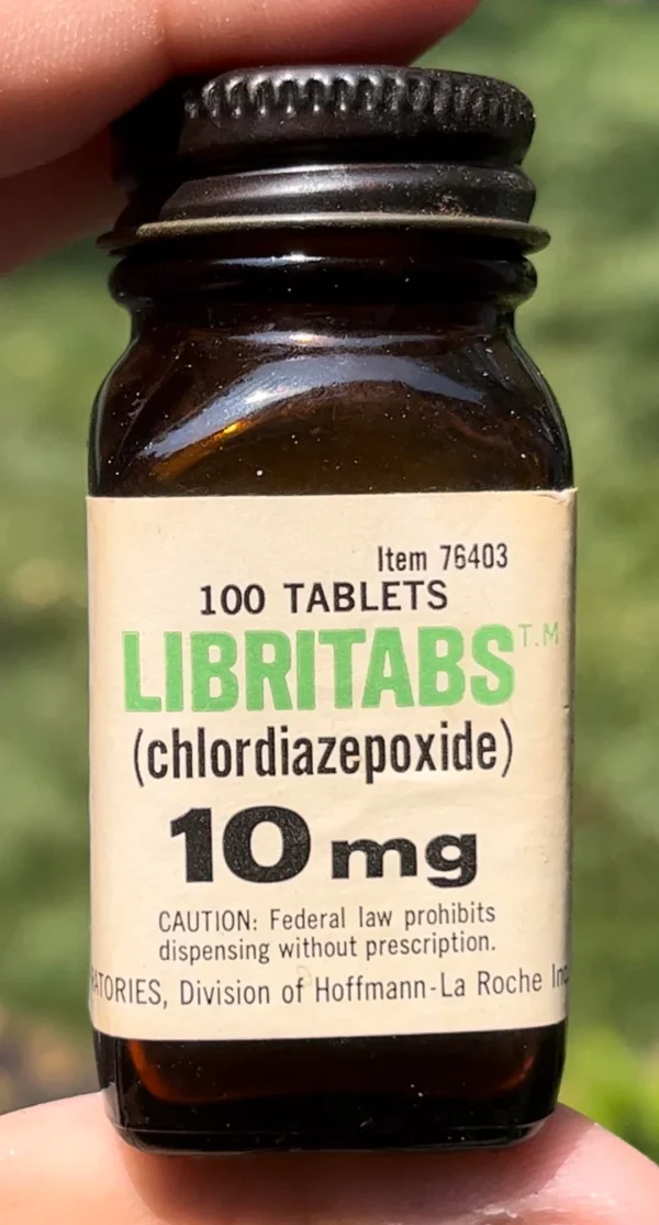 100 Librium 10 mg tablets in a sealed bottle held in hands, showcasing the packaging and quantity of the medication.