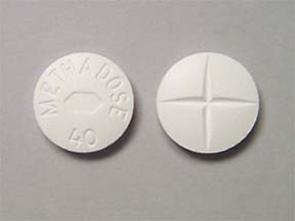 Front and back view of Methadose oral tablet on a clean surface, showcasing its appearance and packaging for informational purposes. Methadose Oral Tablet