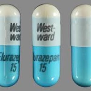 Three Flurazepam capsules on a clean surface, displaying both the front and back views for clarity.