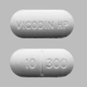 Front and back view of Vicodin oral tablet, showcasing its design and labeling for identification.