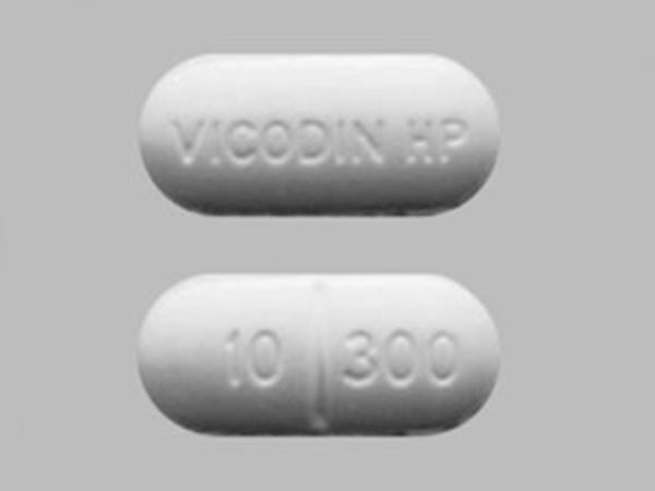 Front and back view of Vicodin oral tablet, showcasing its design and labeling for identification.